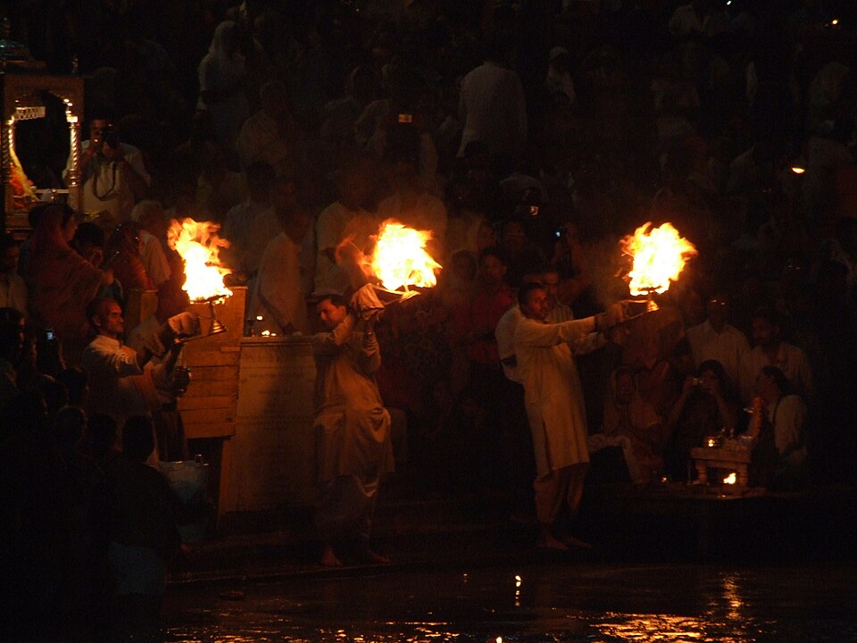 Priests raise flaming aarti lamps at Har Ki Pauri, Haridwar, after dark