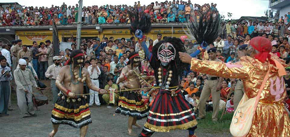 Masked Hilljatra performers before a village crowd in Pithoragarh