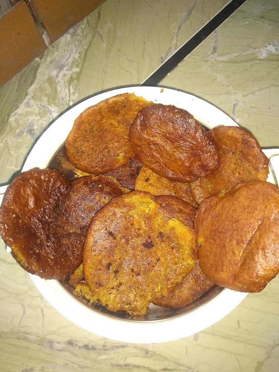 Home-made arsa, deep-fried rice and jaggery sweets on a plate