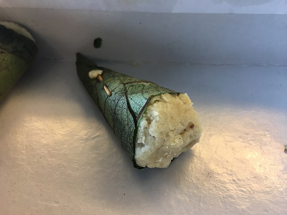 A singori: khoya sweet wrapped in a cone of green malu leaf